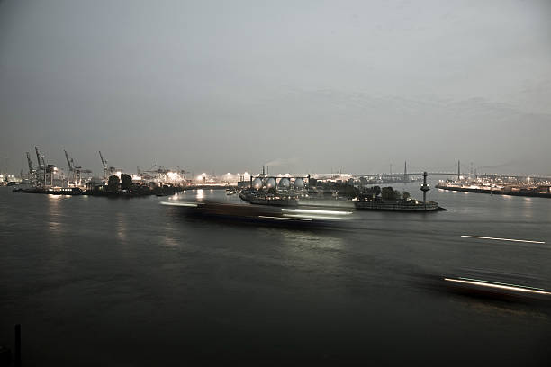 passing container ships, port hamburg at night