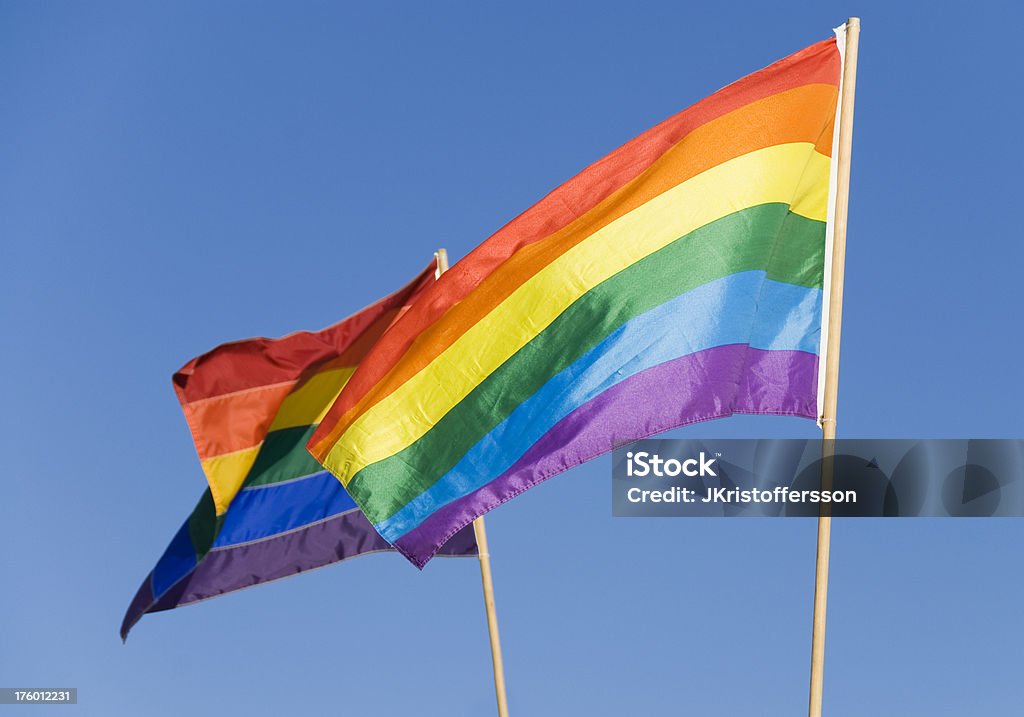 Gay Pride Rainbow Flags Two Rainbow flags at a Gay Pride festival. Vibrant colors. Focus on the forward one. Bright Stock Photo
