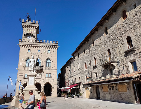 Citta di San Marino, San Marino - October 2, 2023: People going at Palazzo Pubblico or Public Palace. It is the town hall of the City of San Marino and is situated on piazza della liberta..
