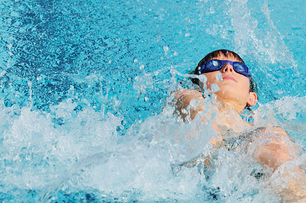 istock Young Boy Backstroke Swimmer Racing in Pool 176012433