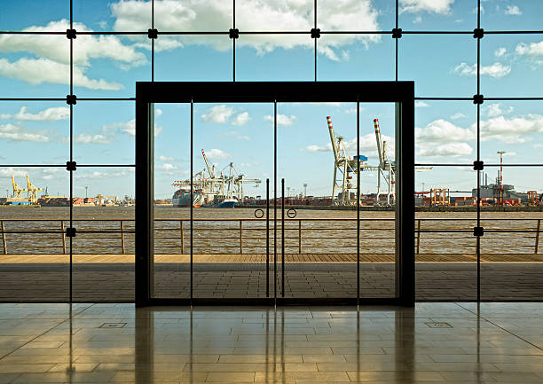 looking from the inside through a glass front  over port hamburg...