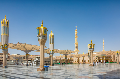 Courtyard of the Al Haram or Al-Masjid an-Nabawi mosque in Medina Saudi Arabia on a sunny day.