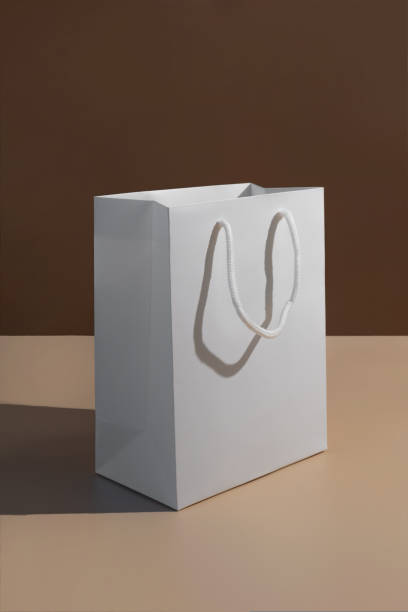 istock Paper shopping bag on brown background. 1760129604