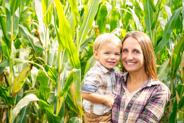 istock Mother and Toddler Son Smiling Outdoors by Corn Stalks 1760138034