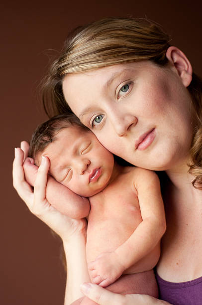 istock Mother Holding Her Newborn Baby 176014094