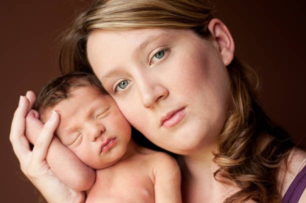 istock Mother Holding Her Newborn Baby 176014096