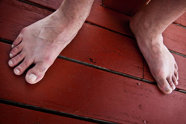 Feet standing on a wood deck stock photo