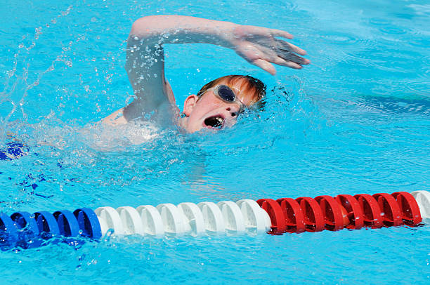istock Young Boy Swimming Freestyle Stroke Race in Pool 176015228