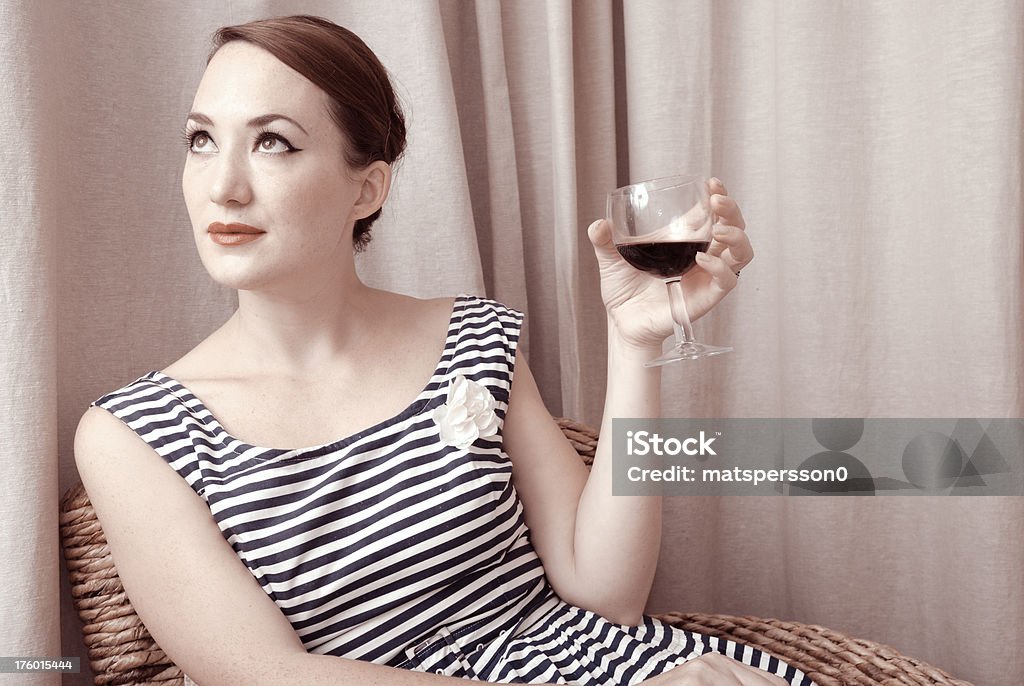 Attraente donna seduta con vino rosso - Foto stock royalty-free di 1940-1949