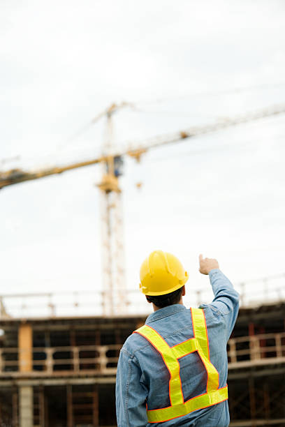 istock Construction Man Wearing Hard Hat at Job Site Pointing 176015611