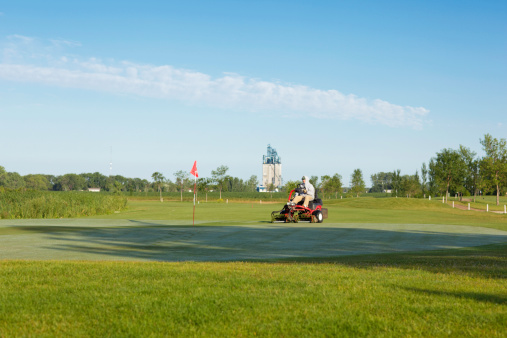 Greens Keeper mowing the green