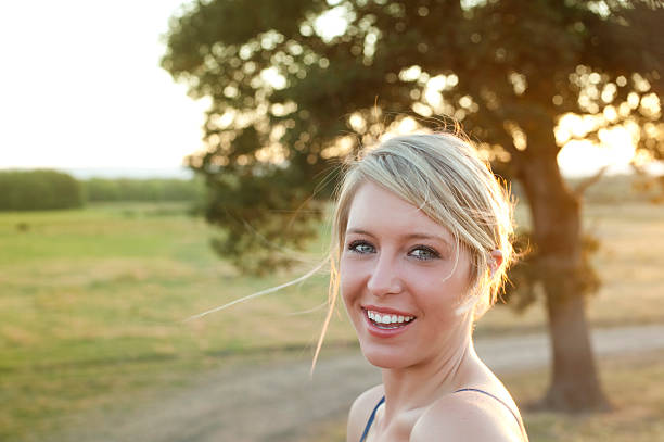 smiling blond in rural pasture stock photo