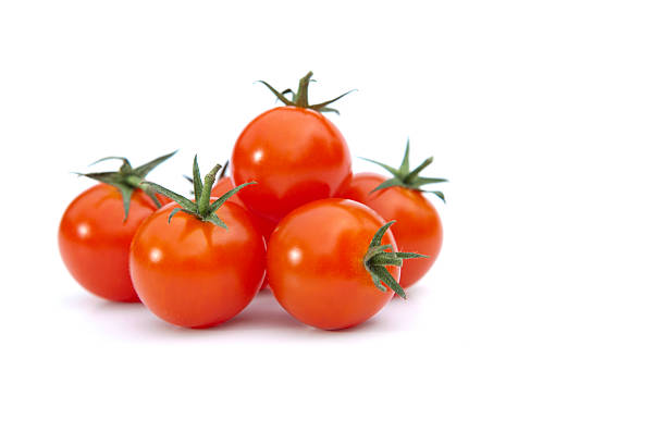 Pile of cherry tomatoes in with background Small red tomatoes with stem. White background cherry tomato stock pictures, royalty-free photos & images