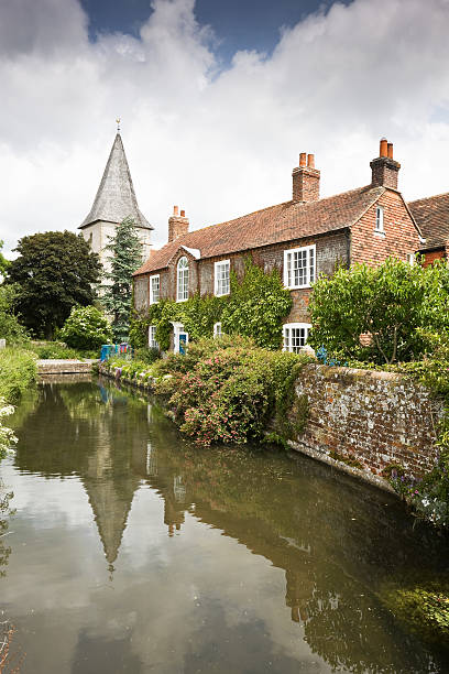 istock English Church with House and Stream 176016870