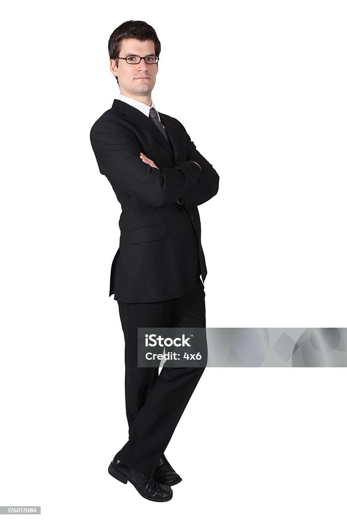 Businessman folding arms and crossing leg Adult Stock Photo