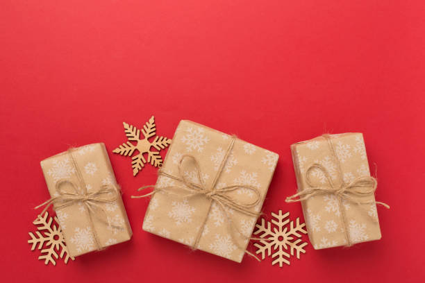 istock Craft christmas gift boxes on color background, top view 1760174034