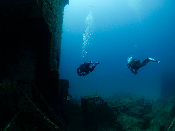 istock scuba divers investingating a shipwreck 176017709