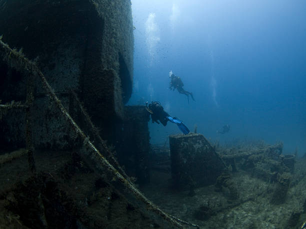 istock scuba divers investingating a shipwreck 176017875