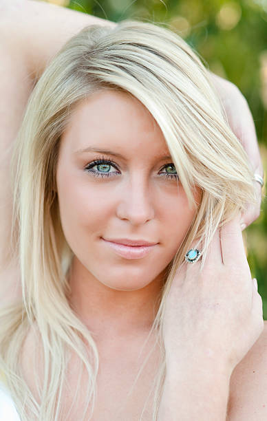 outdoor headshot of young blonde woman stock photo