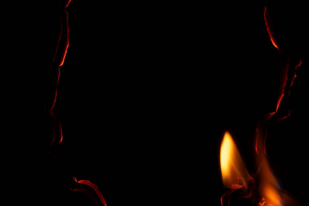 istock burning paper, glowing edge of paper on a black background 1760182031