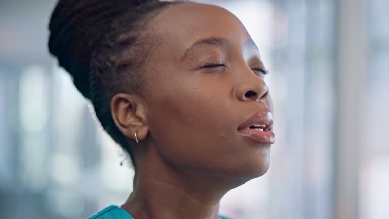 Black woman, breathing and meditation, nurse in a hospital with zen and calm, healthcare and wellness. Face, peace of mind and mental health, healing and holistic, spiritual and faith with medicine