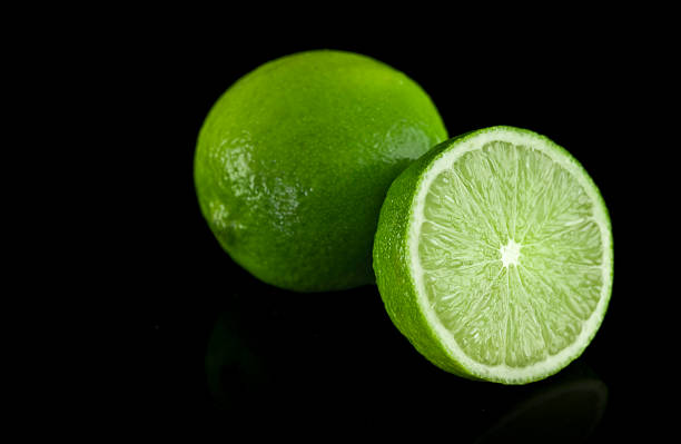 Limes on black background stock photo