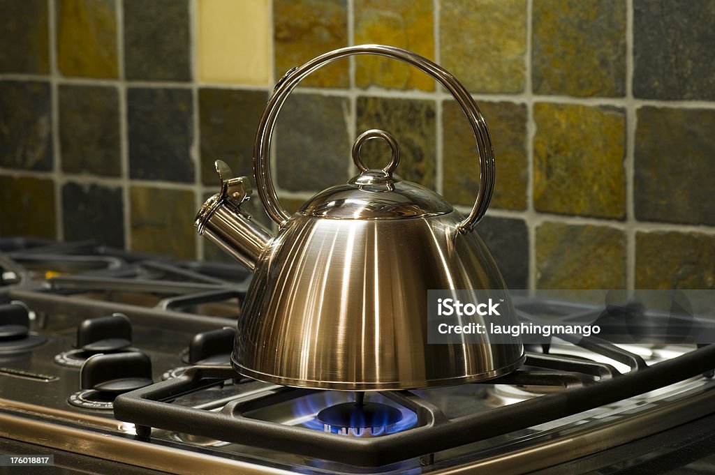 tea kettle flame stove tile utensil tea kettle gas stove burner Apartment Stock Photo