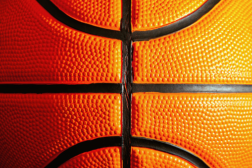 Bright detailed texture official leather orange basketball. Streetball and hoops. Sports patterns and backgrounds