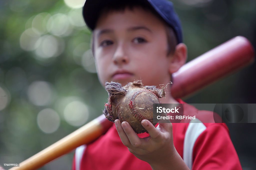 Power hitter a boy holding a destroyed baseball Baseball Bat Stock Photo