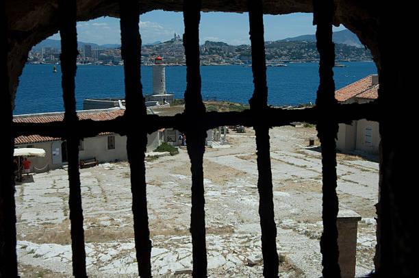 Prison cell "View of the city of Marseille from a prison cell on the  Chateau D'if Island, features in the novel The Count of Monte Cristo" frioul archipelago stock pictures, royalty-free photos & images
