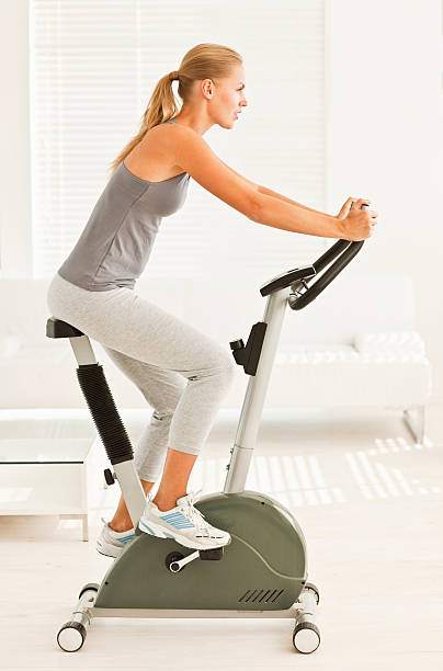 istock Young woman training on an exercise bike 176019325