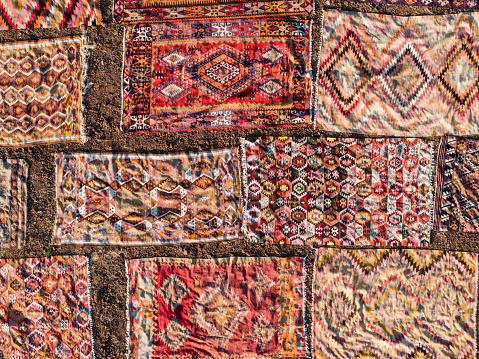 Aerial view of colourful carpets  under sunlight for accelerated ageing. Taken via drone. Antalya, Turkey.