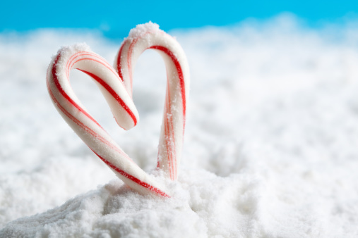 A heart made of candy canes on snow. You may also like: