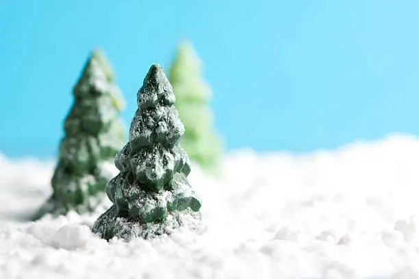 Miniature snowy winter landscape with copy space and christmas trees. You may also like: