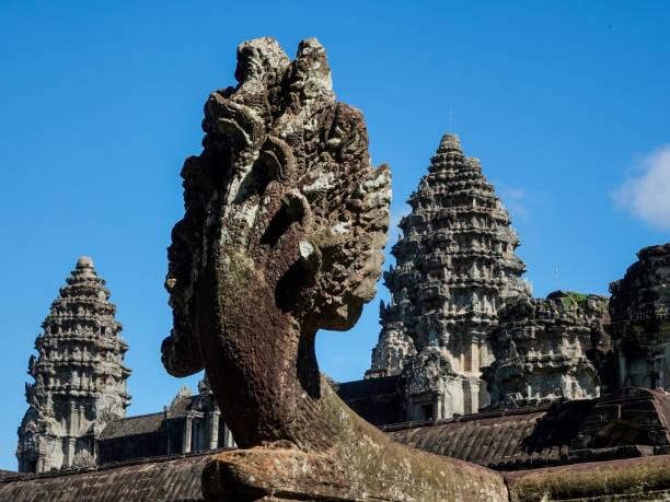 Ankor Wat towers and foreground multiheaded snake sculpture.