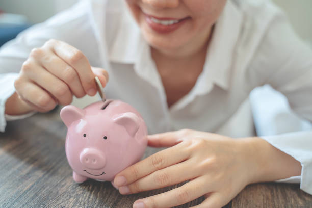 istock Holding piggy bank 1760218975