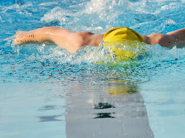 istock Young Boy Butterfly Stroke Swimmer Racing in Pool 176022302
