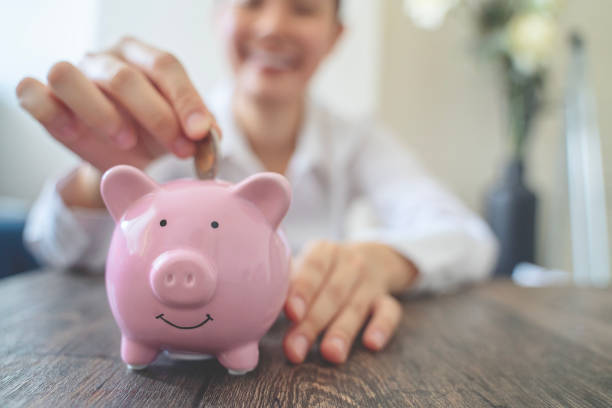 istock Holding piggy bank 1760228624