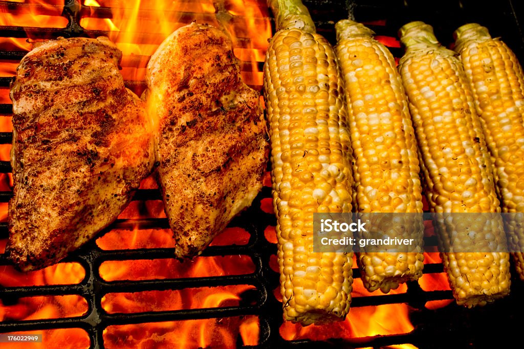 Grilled Chicken and Corn Chicken and corn engulfed in flames on a grill Barbecue Grill Stock Photo