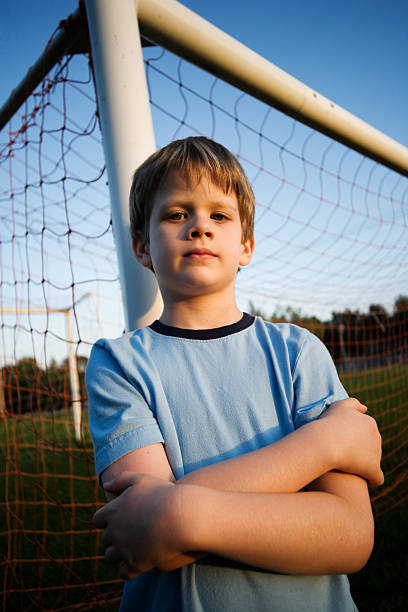 istock Child Standing in Soccer Net Boy Summer 176023398