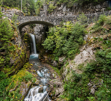 Beautiful waterfall located next to a stone bridge in Mt. Rainier National Park.