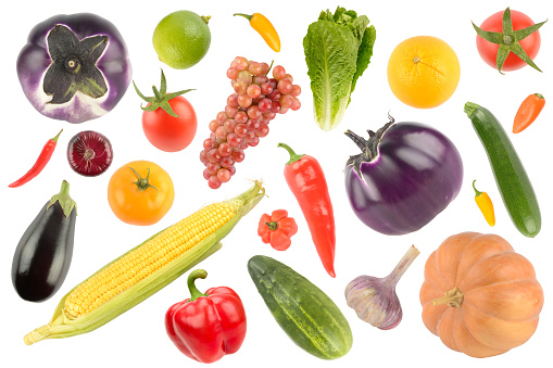 A close up of vegetables in basket on ground with egg plant, bitter gourd, capsicum and peppers.