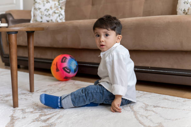 istock Boy playing with soccer ball at home. 1760249353