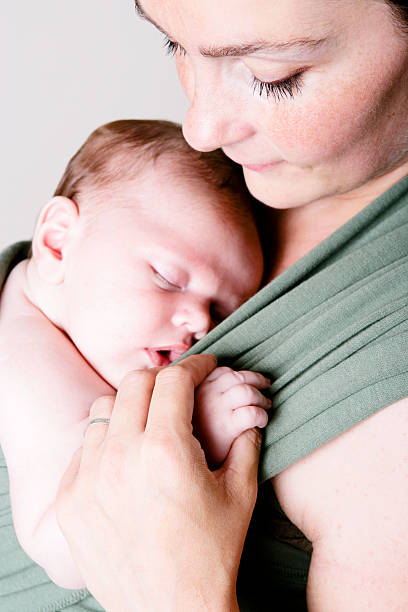 Mother holding her newborn baby stock photo