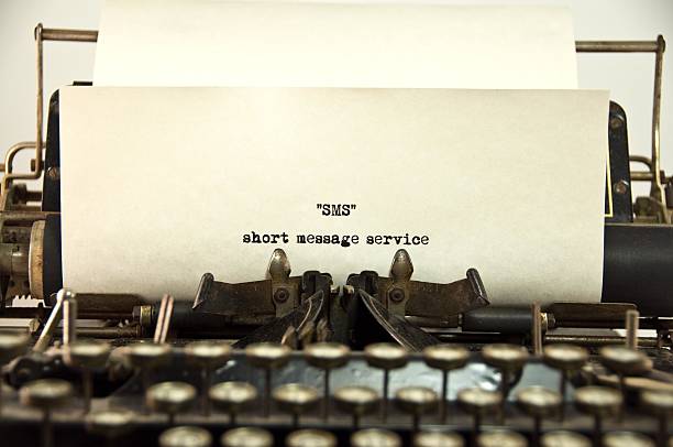Short Message Service On a vintage typewriter "SMS" the acronym for "Short message Service" ... a service offered on mobile phone.... text messaging. typewriter photos stock pictures, royalty-free photos & images