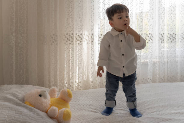 istock Boy playing with a teddy bear in the nursery. 1760259841