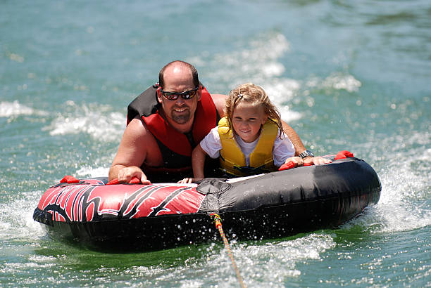 istock Father and Daughter Tubing 176026021