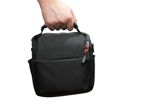 istock Hand holding camera bag isolated on white background 1760262465