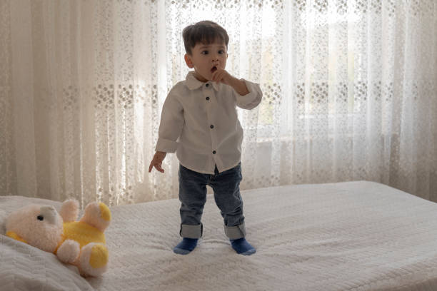istock Boy playing with a teddy bear in the nursery. 1760262478