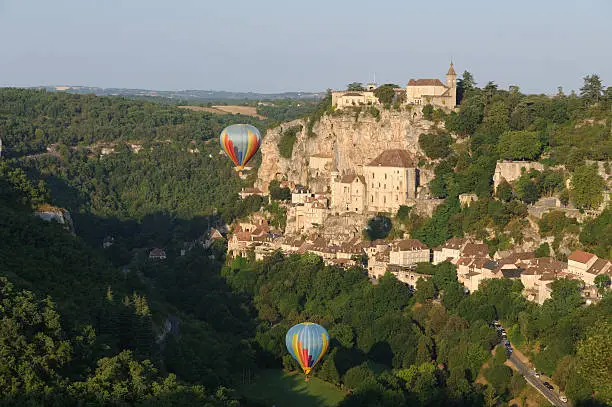 "Famous pilgrim town in southern France ( Midi-PyrAnAes, Lot district) in the morning sun with two hot-air balloons.See also my lightbox ""France"""
